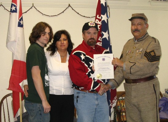 Commander Zoch awards the Plummers an appreciation award for their dedicated service to the camp.